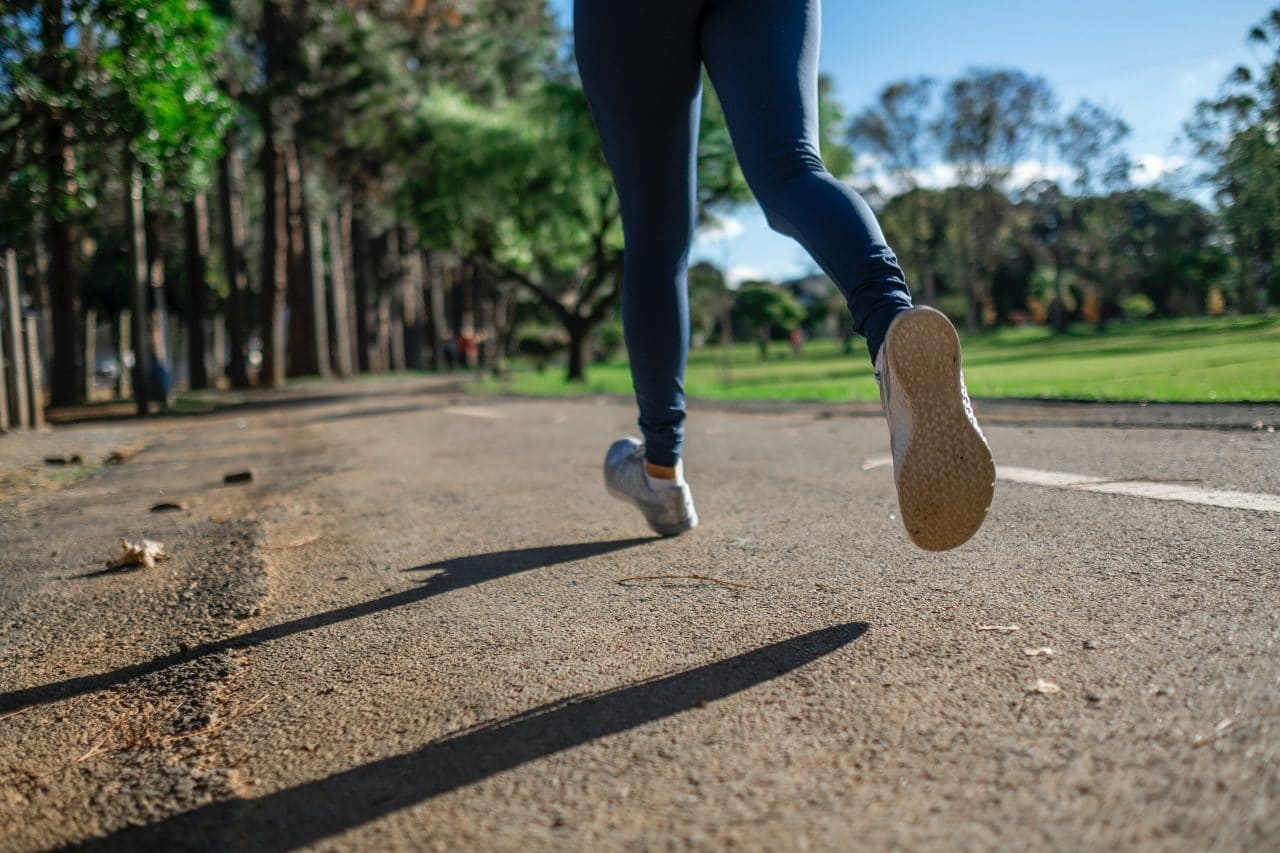 Close up of woman jogging outside.