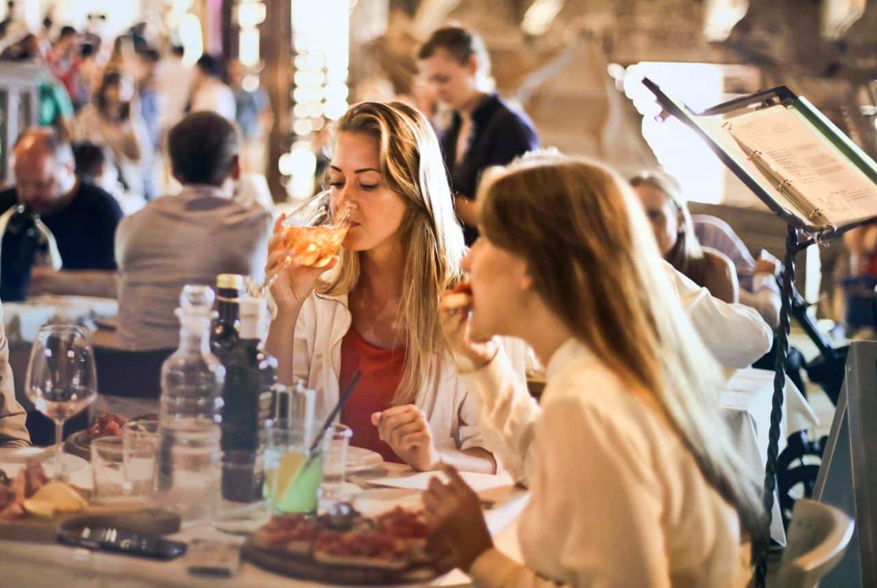 Group of people dining at a crowded restaurant.