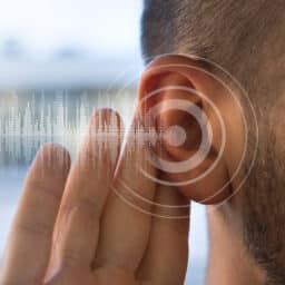 Close up of man holding ear