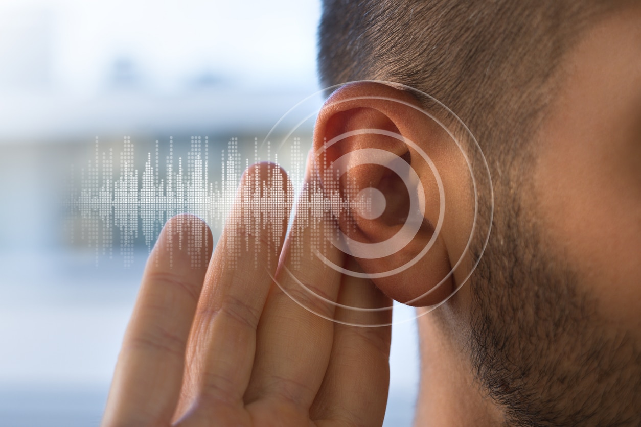 Close up of man holding ear