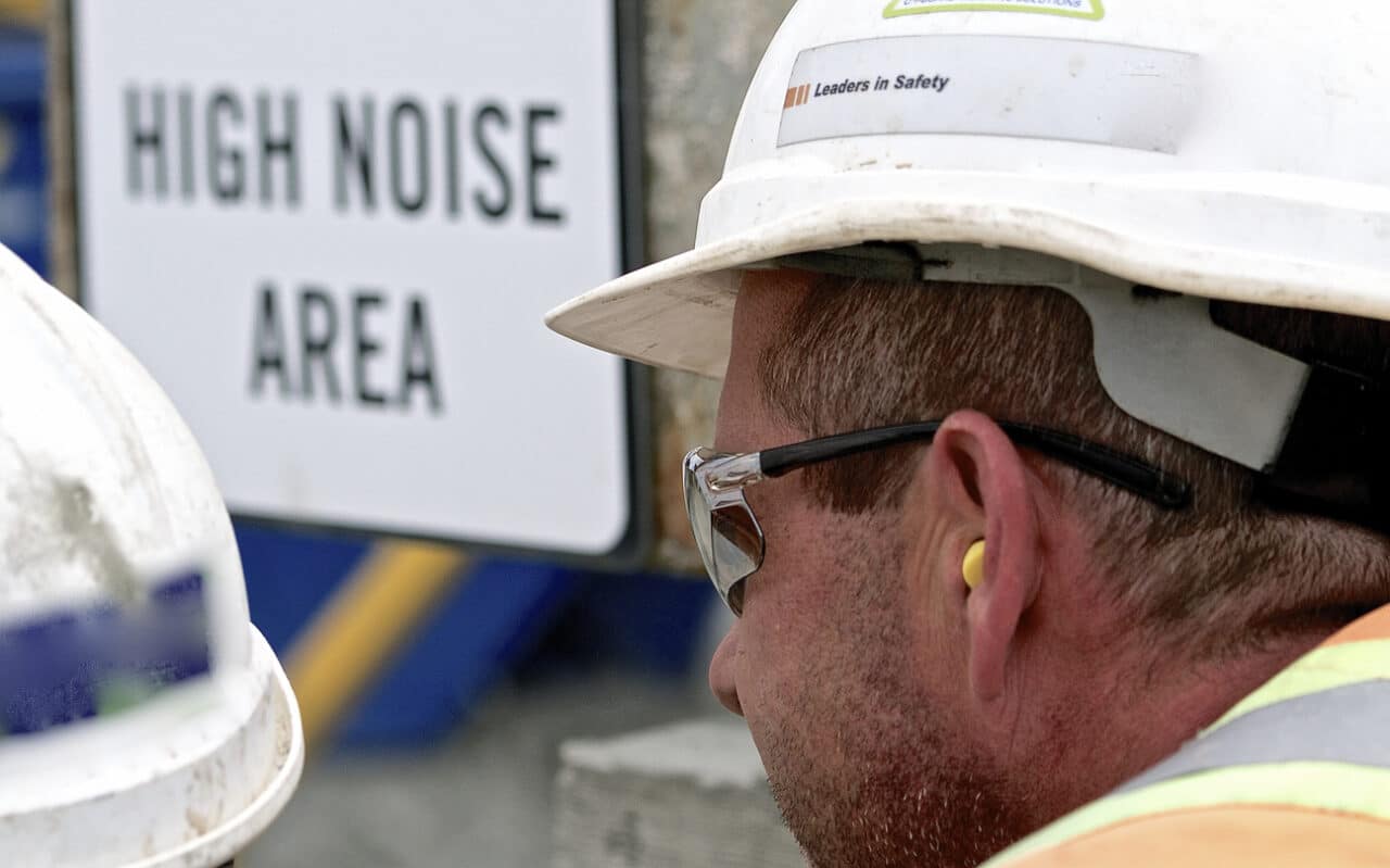 Man wears hearing protection at work