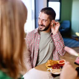 Man with hearing aids at dinner