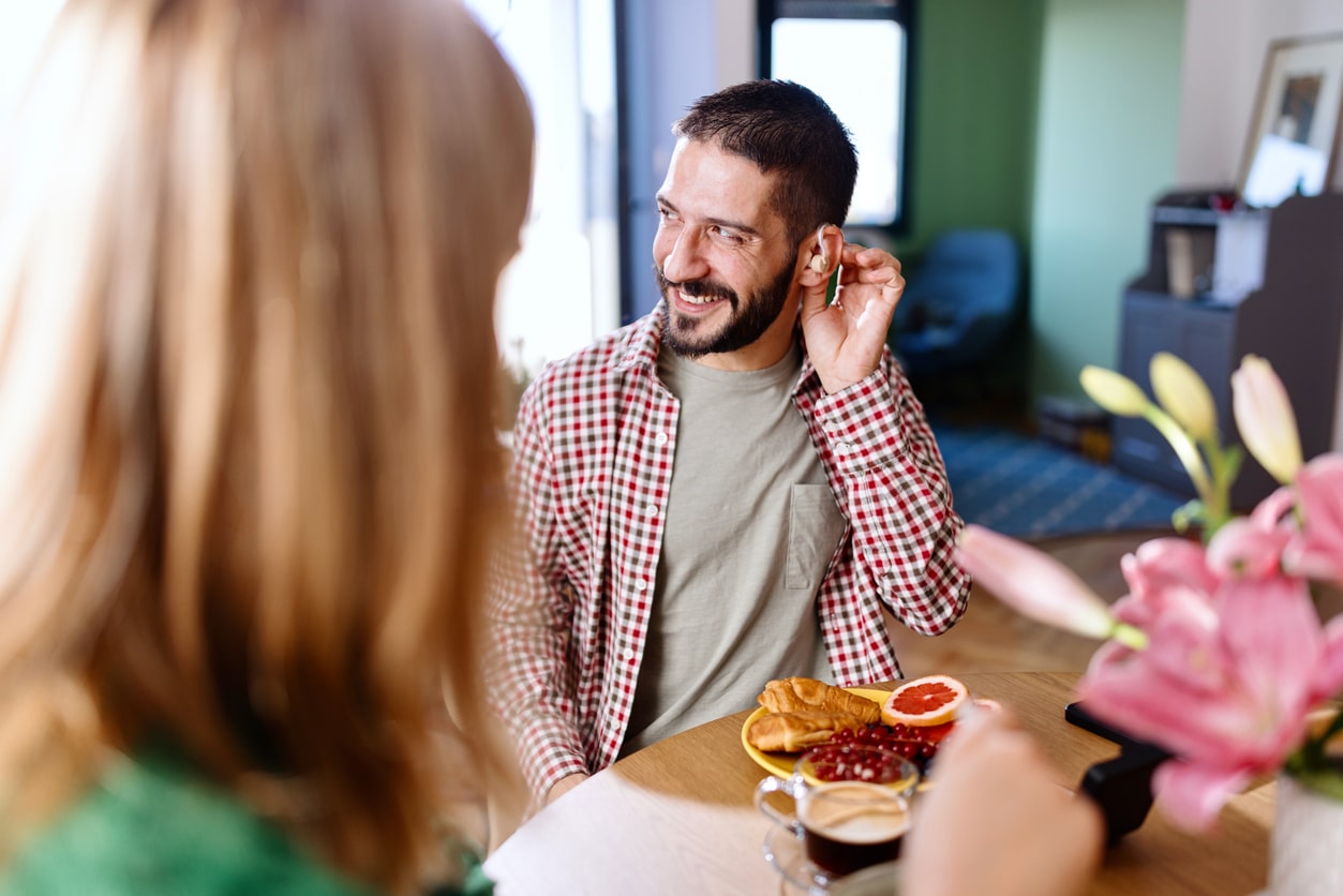 Man with hearing aids at dinner