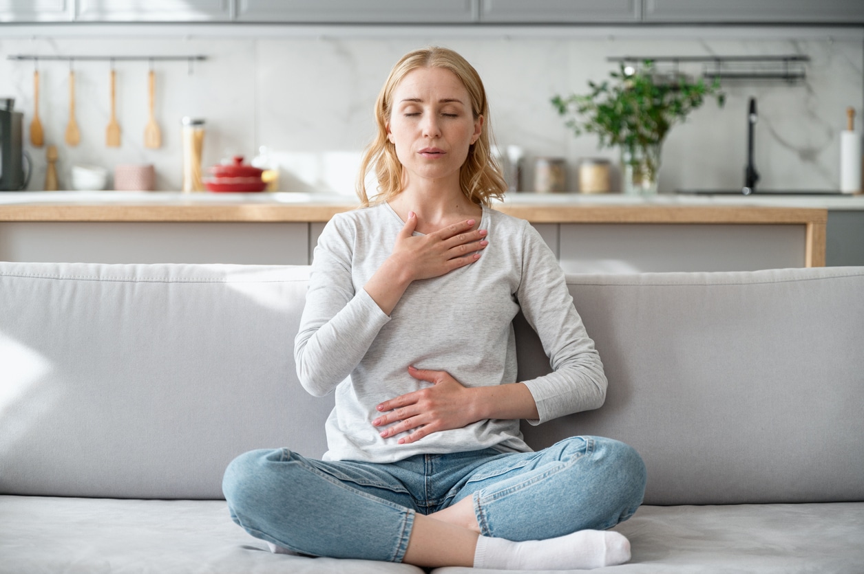 Woman practicing calming breaths.