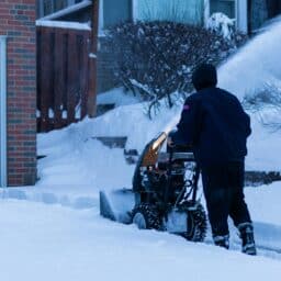 Person using a loud snowblower on their driveway.